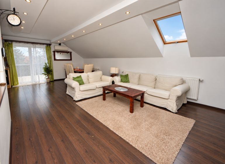 Attic living space with wood-decor flooring in a family house.