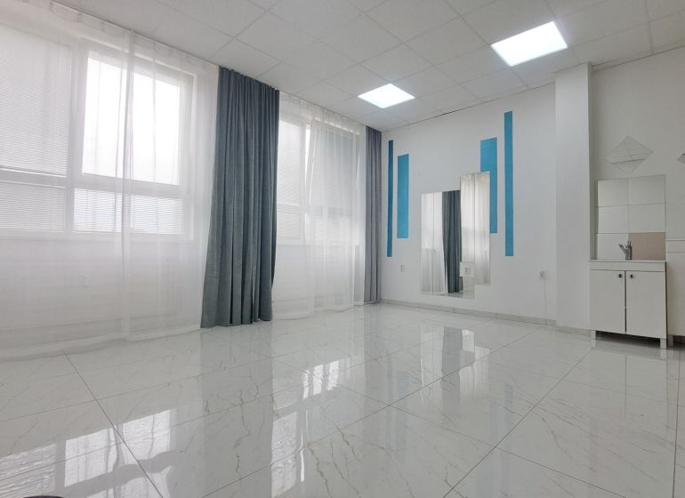 Bright commercial spaces with large windows and mirrors.