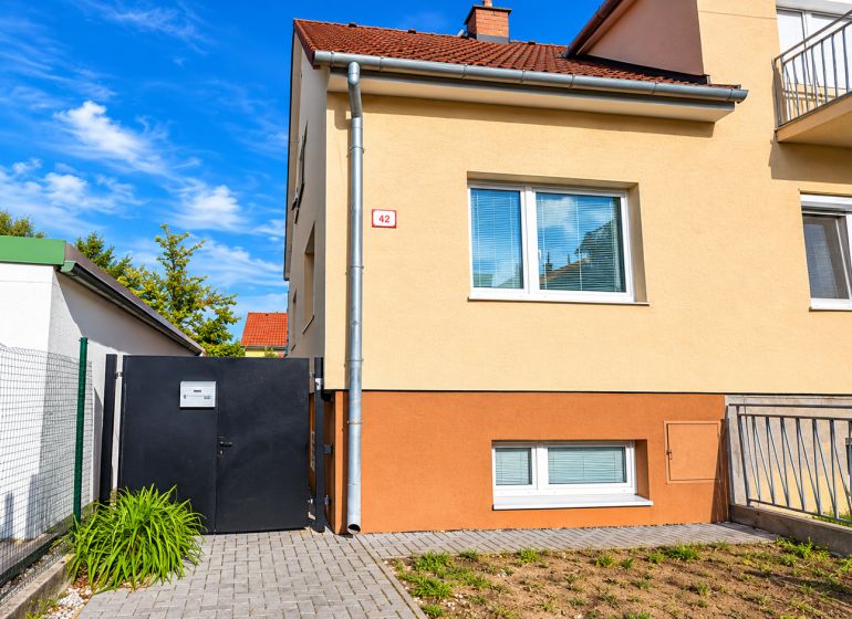 A family house on Kupeckého Street in Piešťany with a fenced yard and an entrance gate.