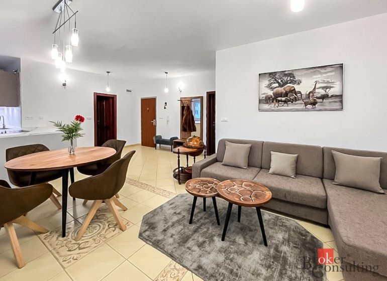 Living room in a 3-room apartment with a comfortable sofa and a decorative painting on the wall.