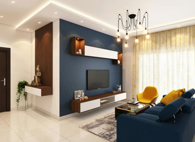 Living room in a 2-room apartment with a blue sofa and stylish lighting.