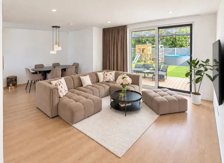 The family house offers a spacious living room with a wooden decor floor and comfortable seating.