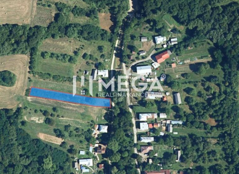 Aerial view of residential plots in Vyšné Ladičkovce surrounded by fields and forest.