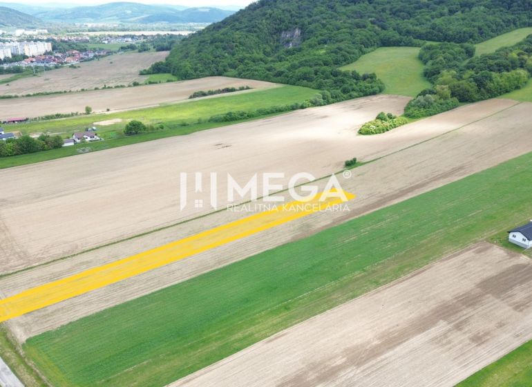 Hilly landscape near Jasenov with residential plots, surrounded by fields and forests.