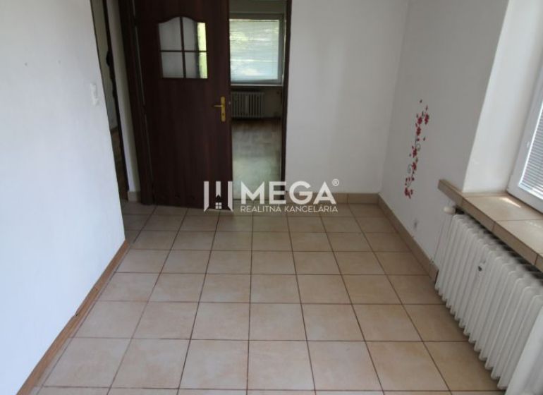 Interior of a 3-room apartment with tiles and wooden doors, illuminated by daylight.