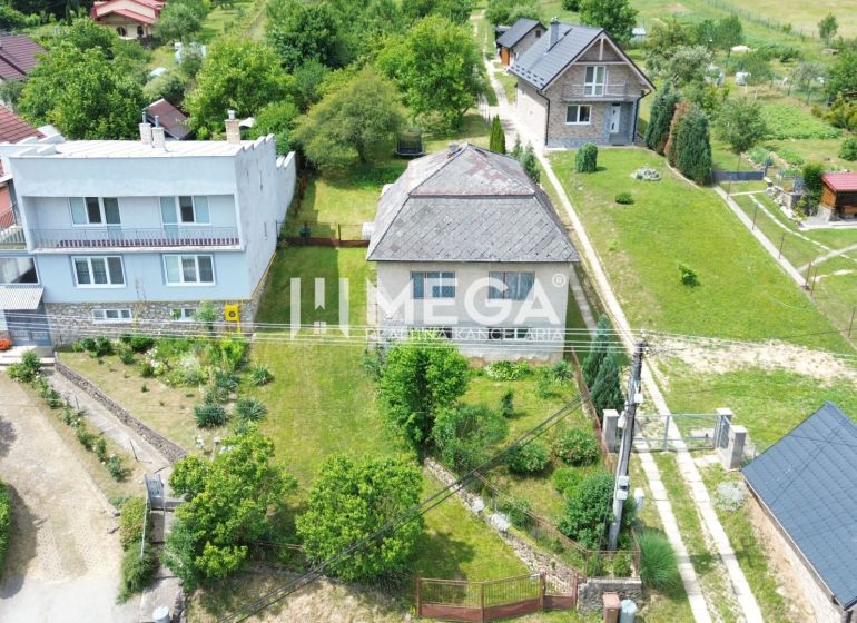 A family house on Jesenského Street in Snina surrounded by a garden and neighboring houses.