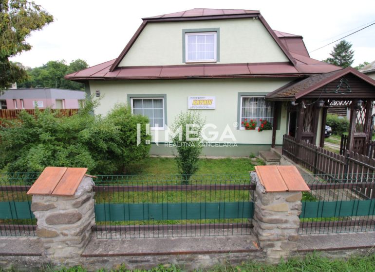 A family house in Ulič at the address Ulič 131 with a front garden and a wooden gate.