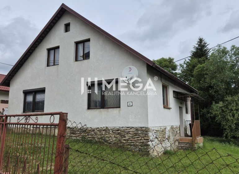 A family house in Zboj with a stone foundation and a garden, surrounded by greenery.