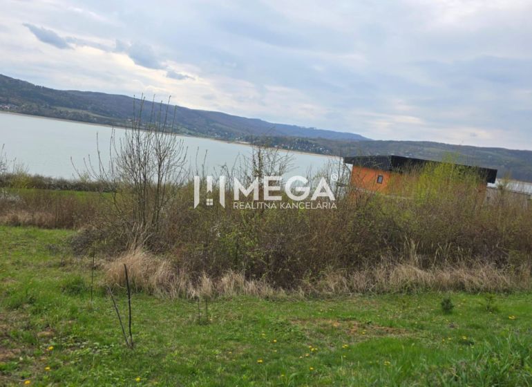 Holčíkovce: Residential plots by the water with a view of the hilly landscape.