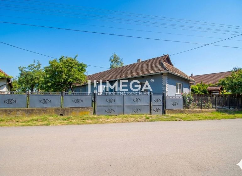 A family house in Veľká Ida with a large gate and garden on a quiet street.