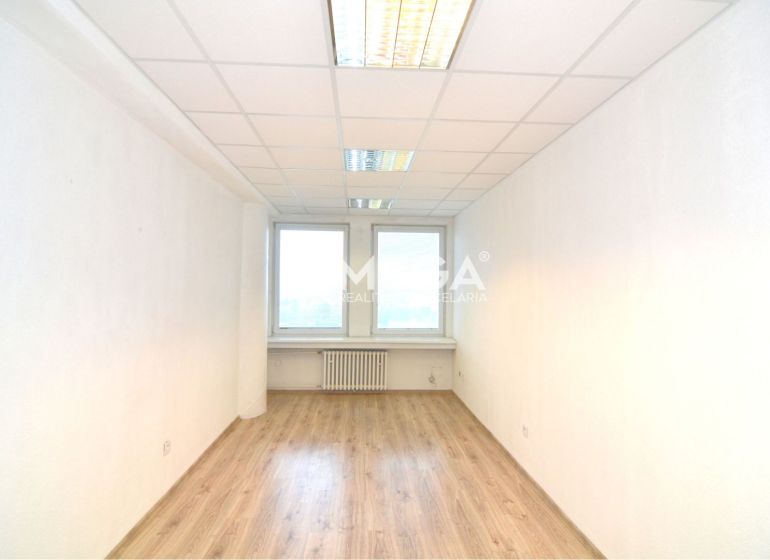 Bright offices with wood-patterned flooring, white walls, and ceiling lights.