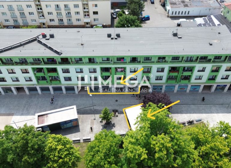 A building with commercial spaces and a pedestrian zone at Freedom Square in Vranov nad Topľou.