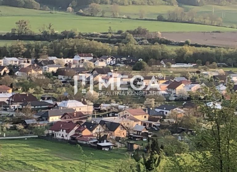 An aerial view of the village Lackovce surrounded by agricultural and forest lands.