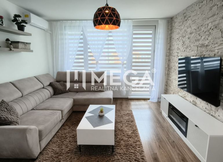 Living room in a 3-room apartment with a corner sofa and a wooden decor floor.