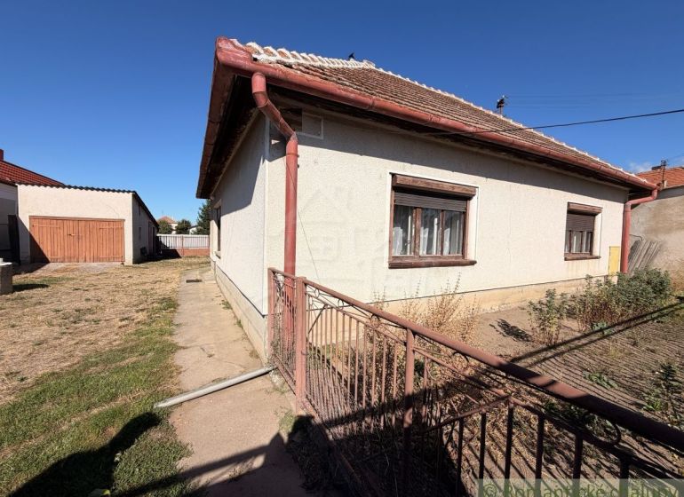 A family house in Hurbanovo with a large fenced garden, an adjacent garage, and a grassy plot.