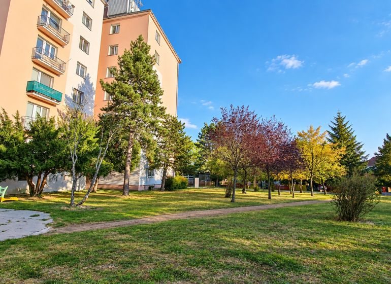 A panel house surrounded by greenery on Za hradbami Street, Pezinok, suitable for a 3-room apartment.