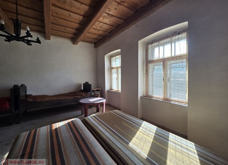 A room in a family house with wooden ceilings and natural light.