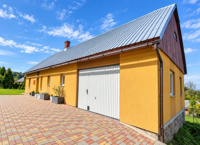 Yellow family house on Košariská Street in Oščadnica with colorful paving.