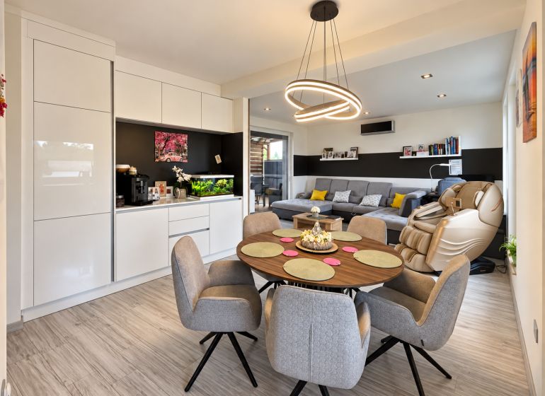 Living room in a family house with wood-patterned flooring and comfortable seating.