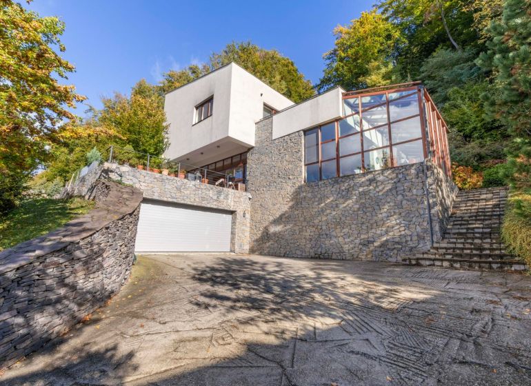 A family house on Karpatská Street in Marianka, surrounded by greenery with a glass terrace.