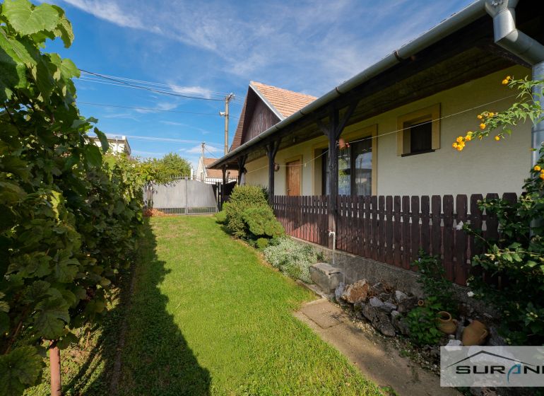 A family house on Hlavná Street in Štefanová with a well-maintained garden and a wooden fence.