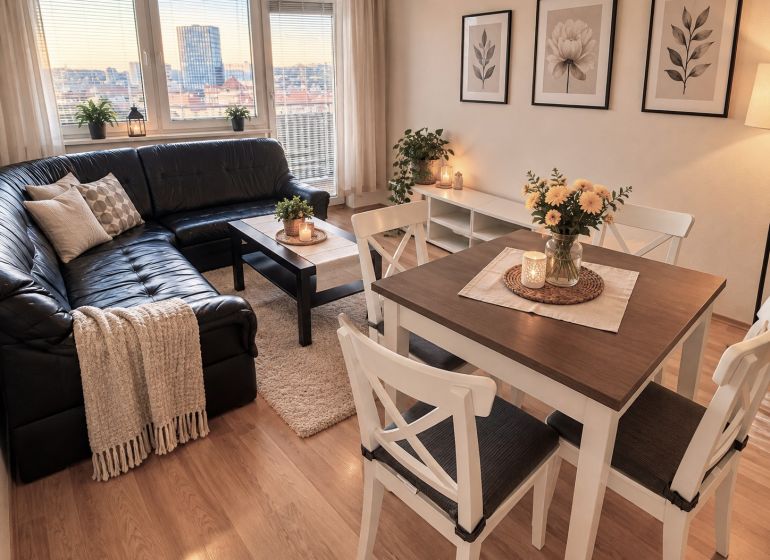 Living room in a 2-room apartment with a leather sofa and a wooden decor floor.
