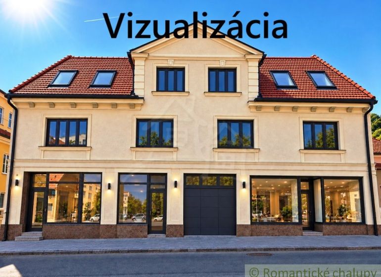 The facade of a building with commercial spaces in the town of Modrý Kameň, capturing glass display windows.