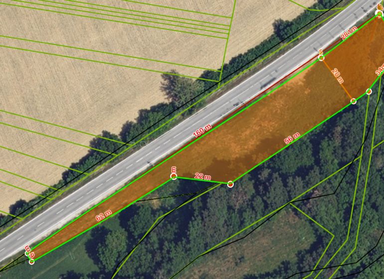 Aerial view of commercial land near the road in Modrovka with plot dimensions.