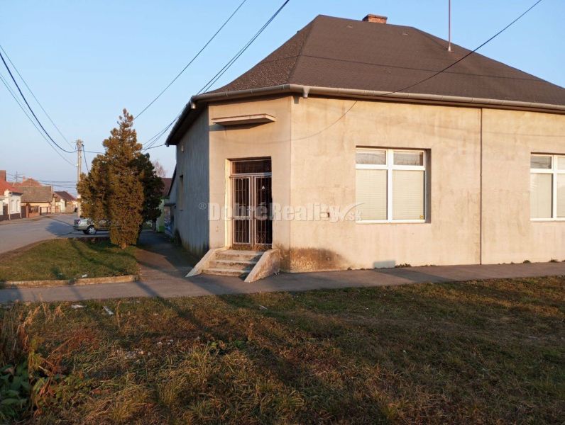 Commercial premises on Hlavná Street in Váhovce, a corner building with two windows and an entrance.