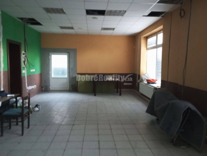 Spacious commercial spaces with windows and doors, tiled floor.