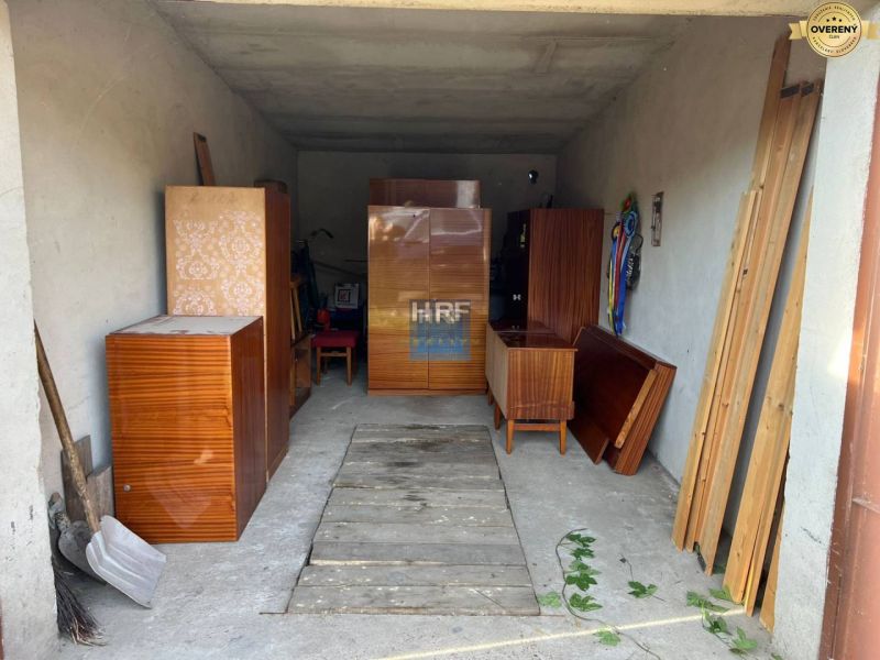 A garage on Veterná Street in Holíč with stored antique furniture and wooden panels.