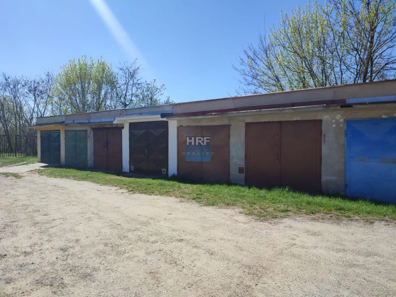 A row of garages on Veterná in Holíč, surrounded by trees and grassy surfaces.
