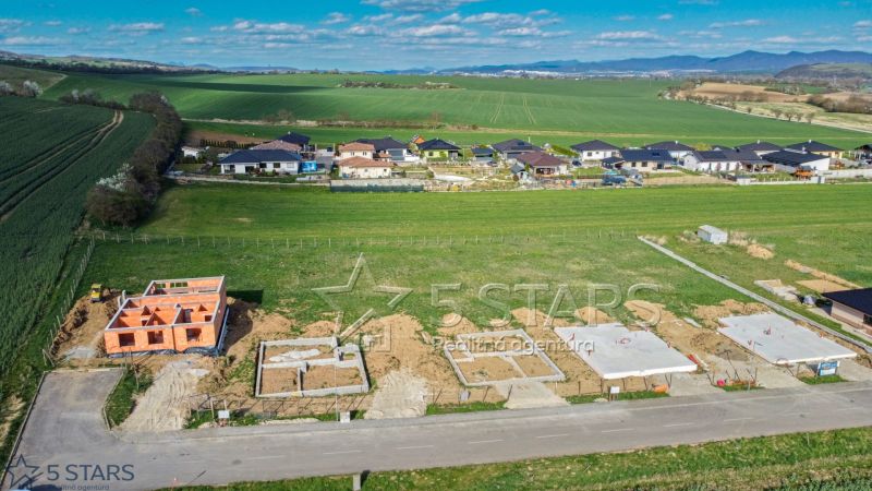 Construction of family houses in Trenčín with a view of the surrounding landscape and greenery.