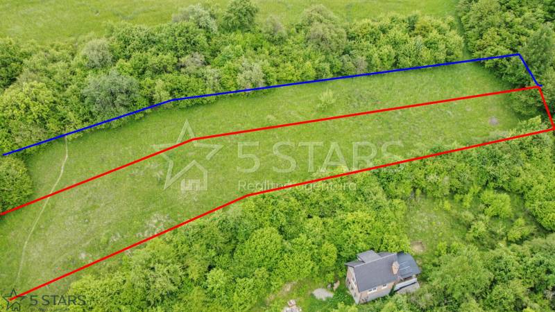 Aerial view of recreational plots in Kostolná-Záriečie surrounded by greenery and trees.