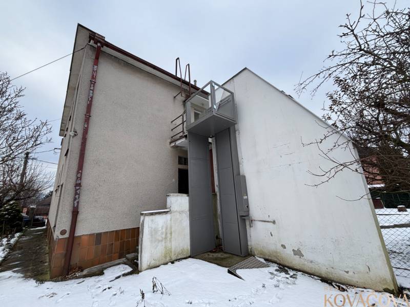 The snow-covered back of the building in Zamarovce, on the outskirts of Trenčín.