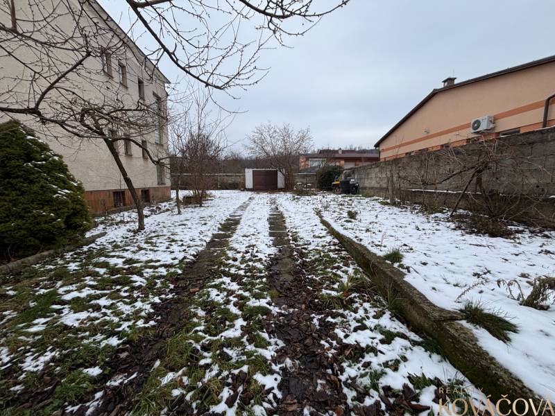 The garden at the 4-room apartment in Zamarovce, Trenčín, covered with snow and fallen leaves.