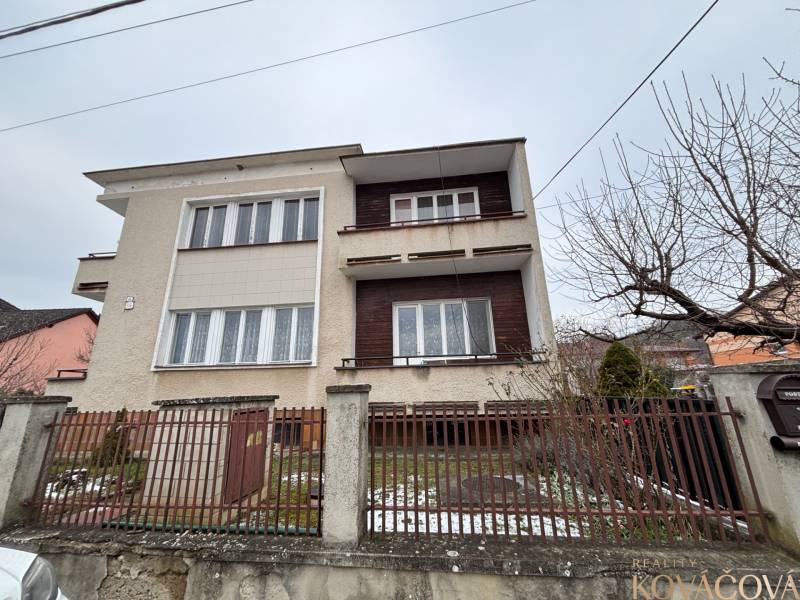 A two-story house in the Zamarovce district of Trenčín, with a metal fence and a garden.