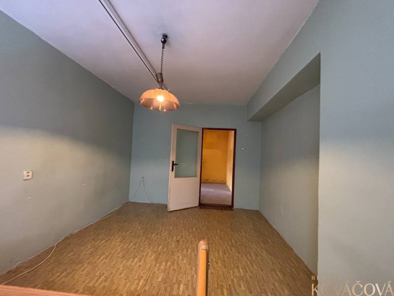 A room in a 4-room apartment with a bright chandelier and open doors.