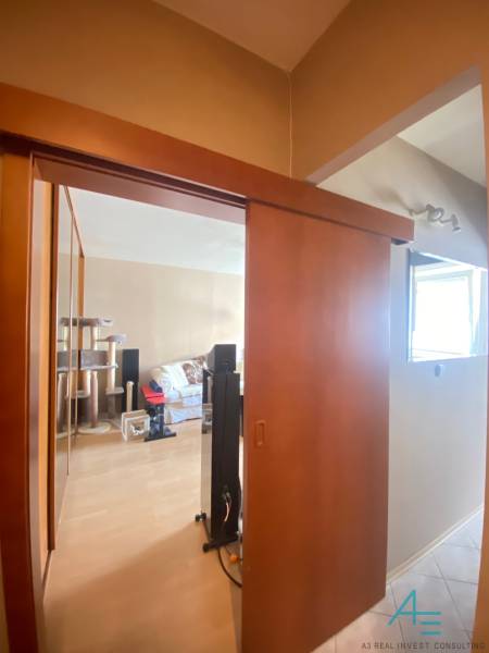 Interior of a 1-room apartment with sliding doors and a comfortable sofa.