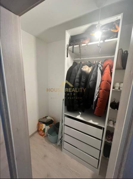 Storage space with a coat rack and shelves in a 2-room apartment.