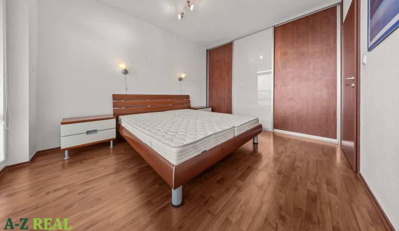 Bedroom in a 2-room apartment with a bed, nightstands, and a wardrobe.