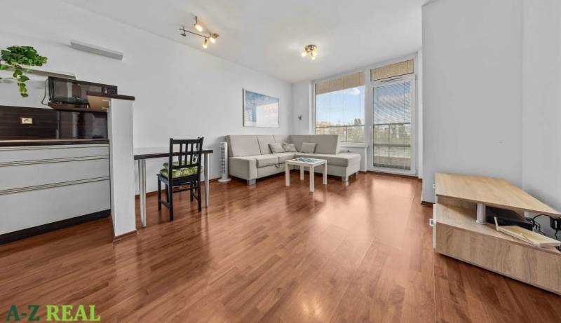 Living room in a two-room apartment with a sofa and a dining table.