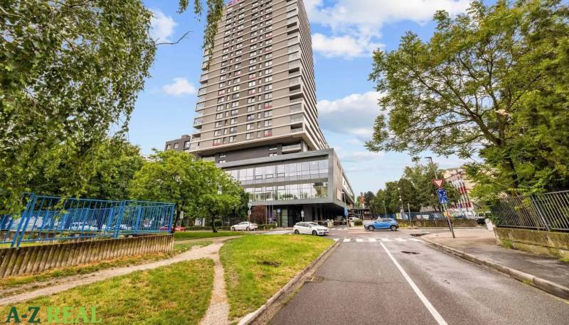 A tall building surrounded by greenery on Nevädzova Street in Bratislava - Ružinov.