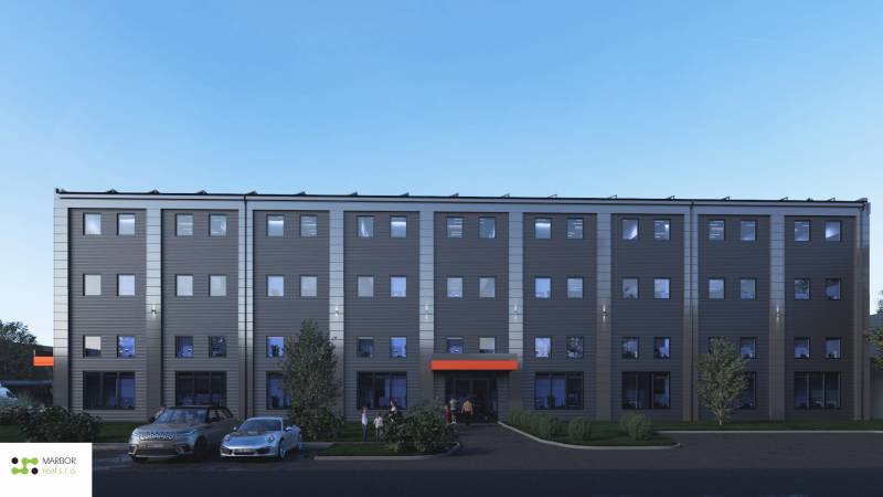 A building with a parking lot in front of warehouses and halls on Južná trieda in Košice - Juh district.