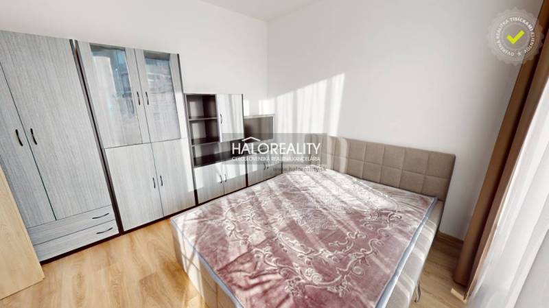 A bright bedroom with a large bed and wardrobes in a 2-room apartment.
