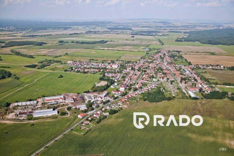 Aerial view of the village Borský Svätý Jur with surrounding fields and buildings.