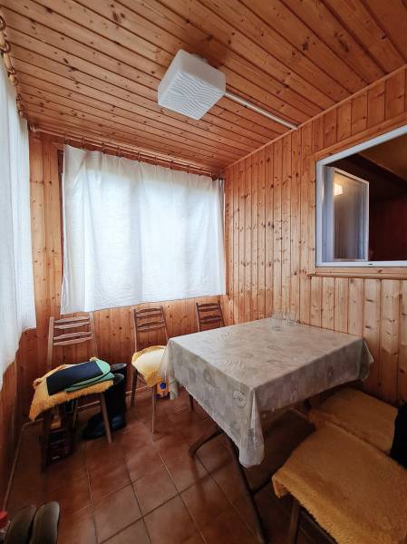 Interior with wood paneling, table and chairs, Home construction.