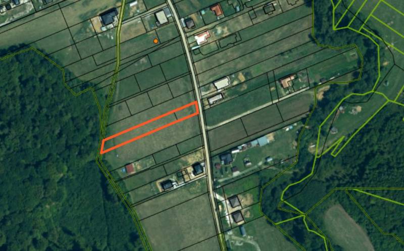 Aerial view of properties - housing in Gregorovce with parcels by the road and forest.