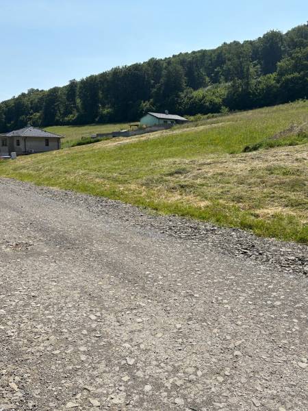 Plots - living in Gregorovce with a grassy slope, forest, and two houses in the countryside.