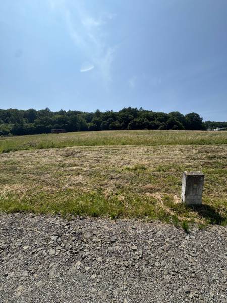 Beautiful natural scenery in Gregorovce, residential plots surrounded by greenery and blue skies.